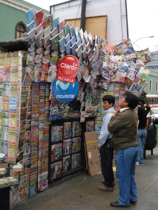 Photo of a street vendor in Lima, Peru selling a huge variety of boulevard press