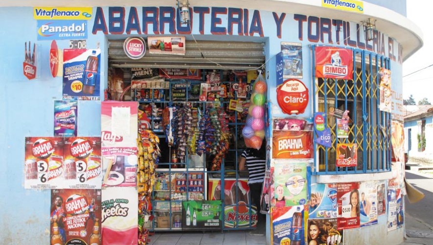 Photo of a tienda in Guatemala with advertisement posters on the wall