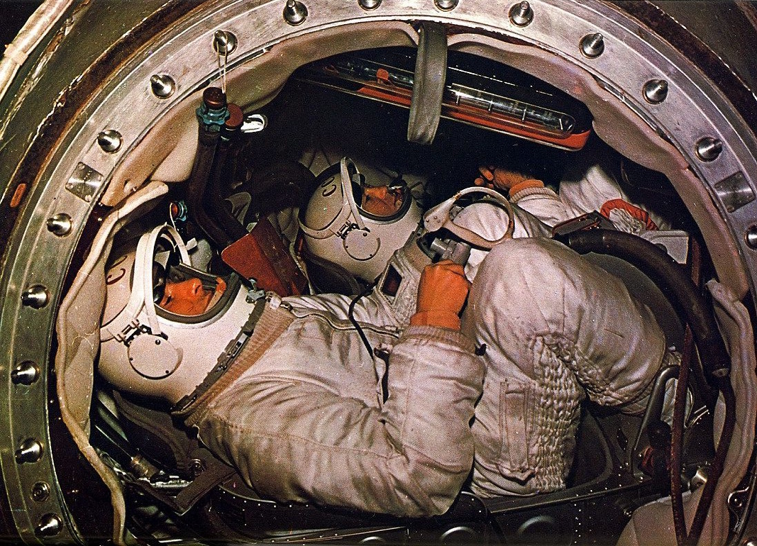 Photo of two cosmonauts sitting in the cockpit of a rocket before launch