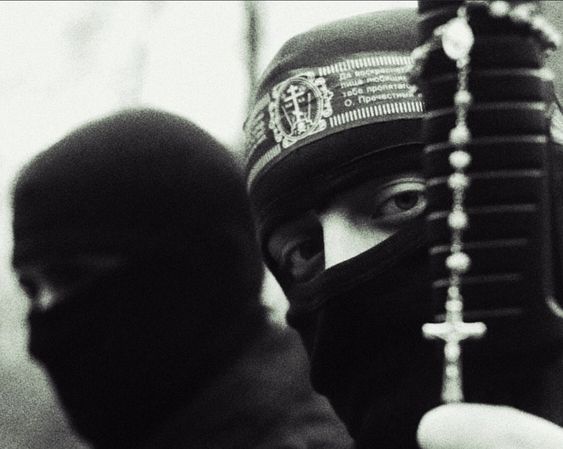 Black-and-white photo of soldiers with balaclavas and headband with orthodox symbols