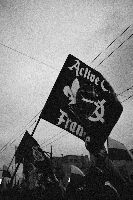Black-and-white photo of a neo-fascist flag at a protest