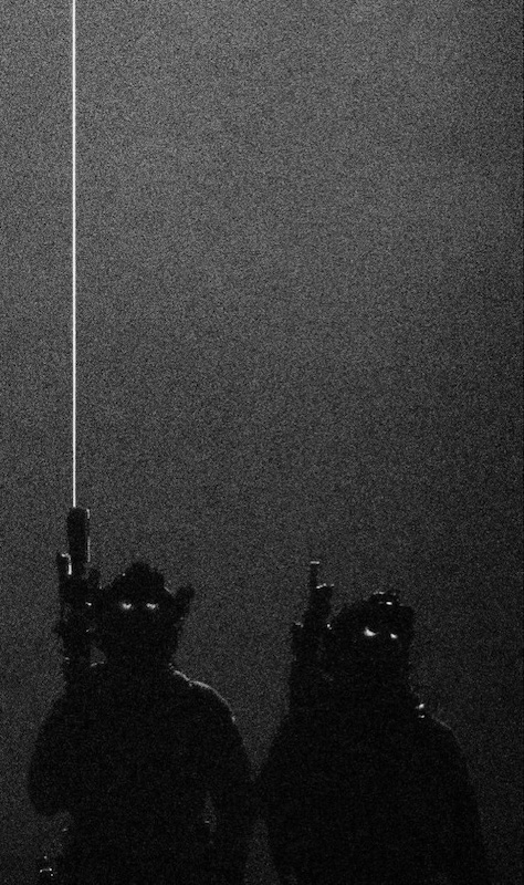 Heavily edited photo of soldiers with laser sights