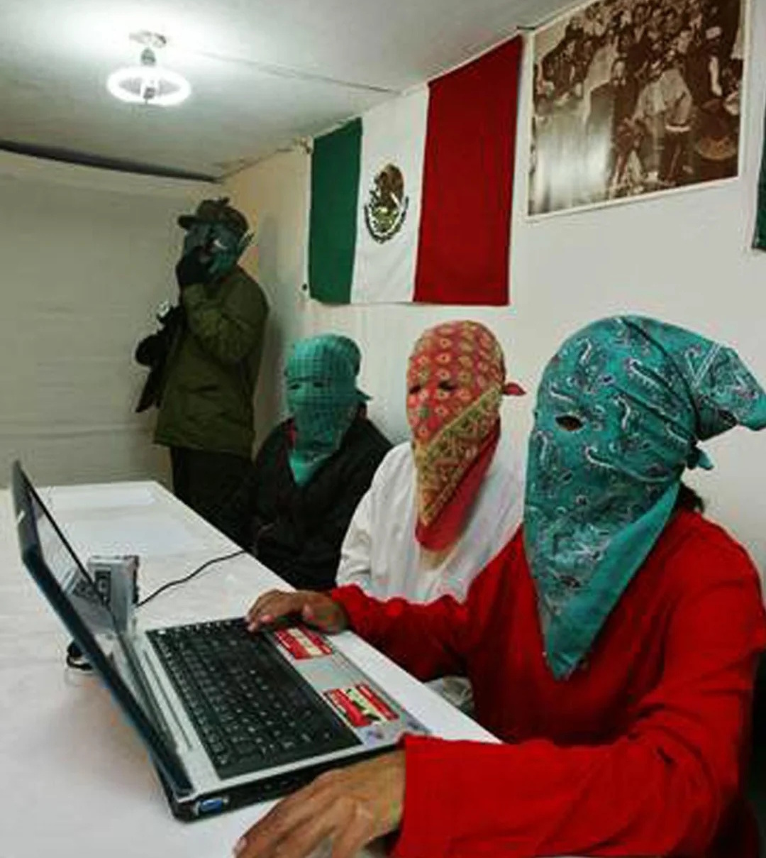 Photo of three masked EPR fighters sitting in front of a laptop
