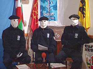 Screenshot of three masked ETA members holding a conference on TV