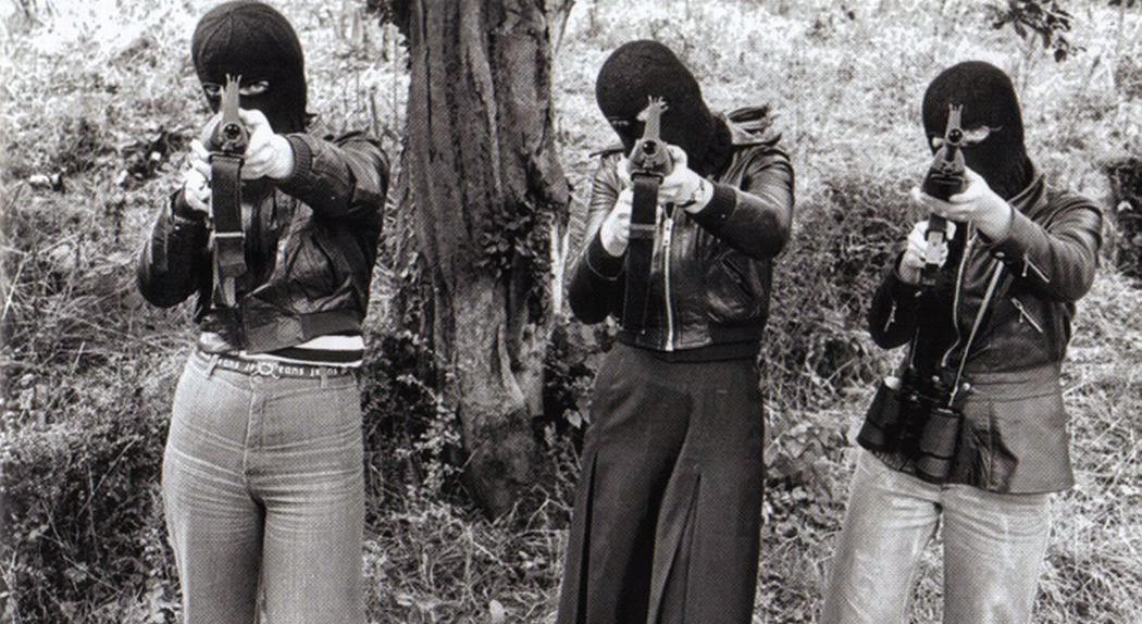 Photo of three female IRA fighters pointing their weapons right at the camera