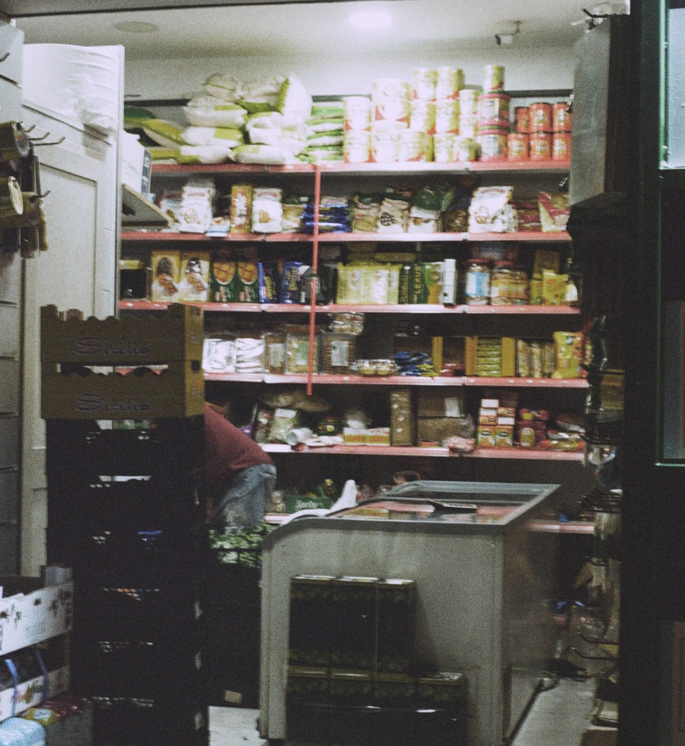 The insides of a small corner store offering various packed foods