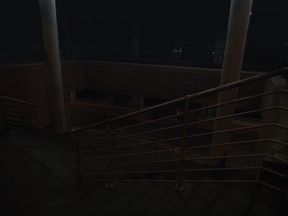 Outdoor concrete stairs leading down to place hidden in night's darkness